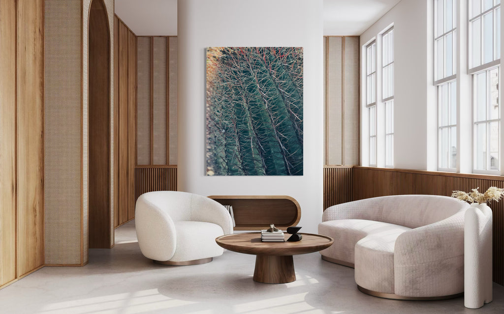 Thorns of Silence fine art artwork displayed above a curved ivory sofa in a modern neutral living room