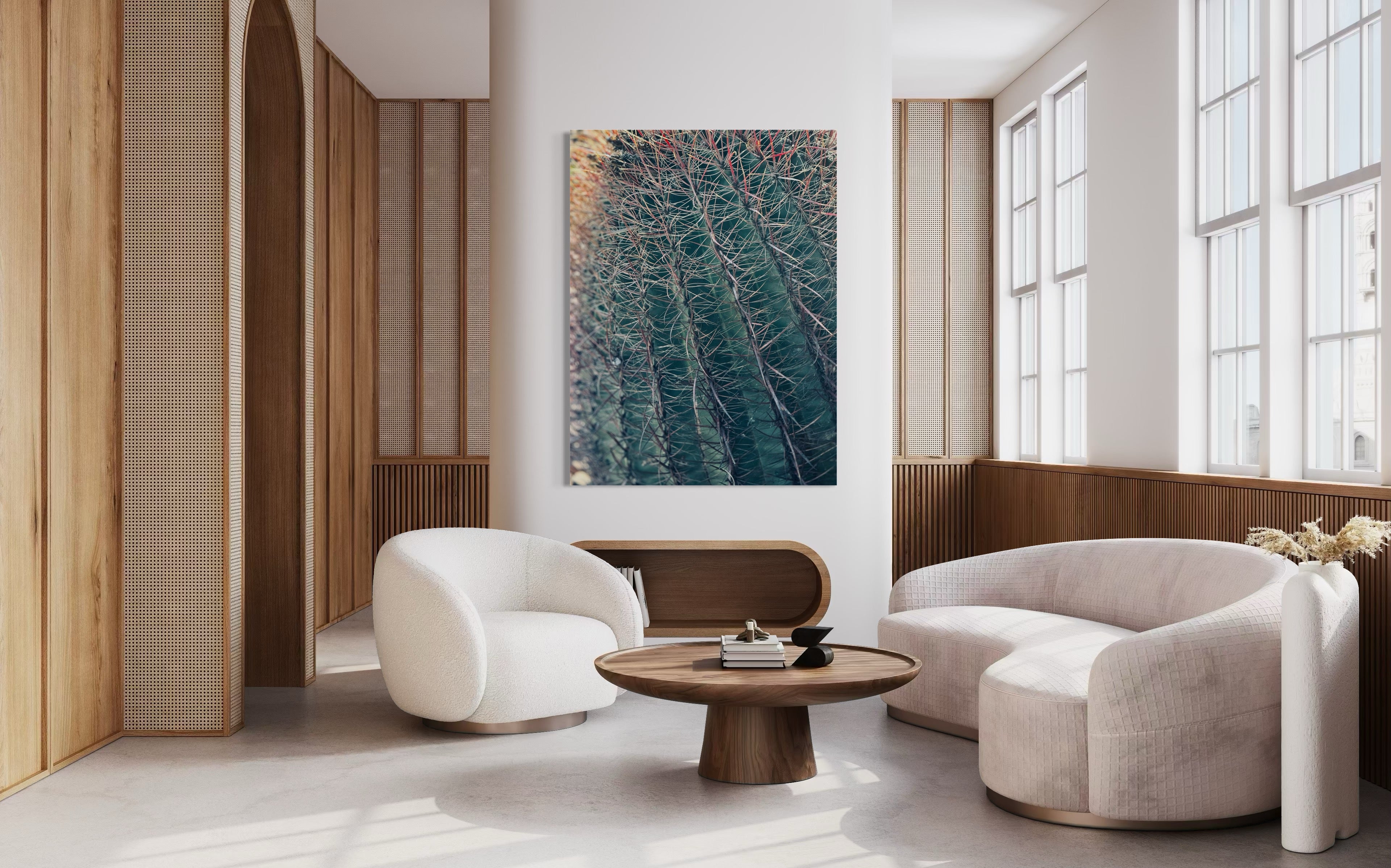 Thorns of Silence fine art artwork displayed above a curved ivory sofa in a modern neutral living room