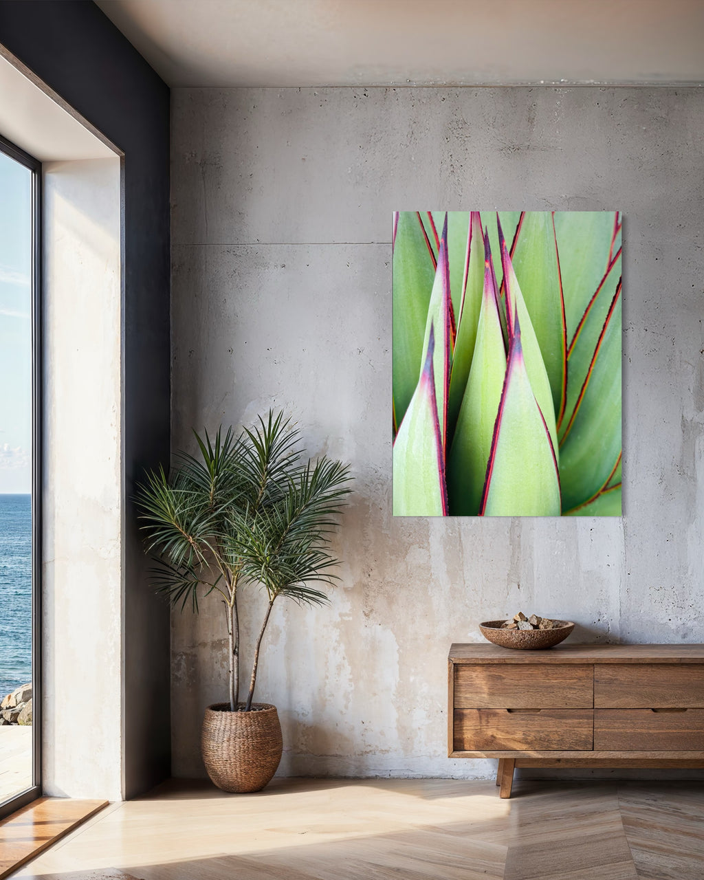“Verdant Lines” fine art piece hanging on a concrete wall beside a large window overlooking the ocean.

