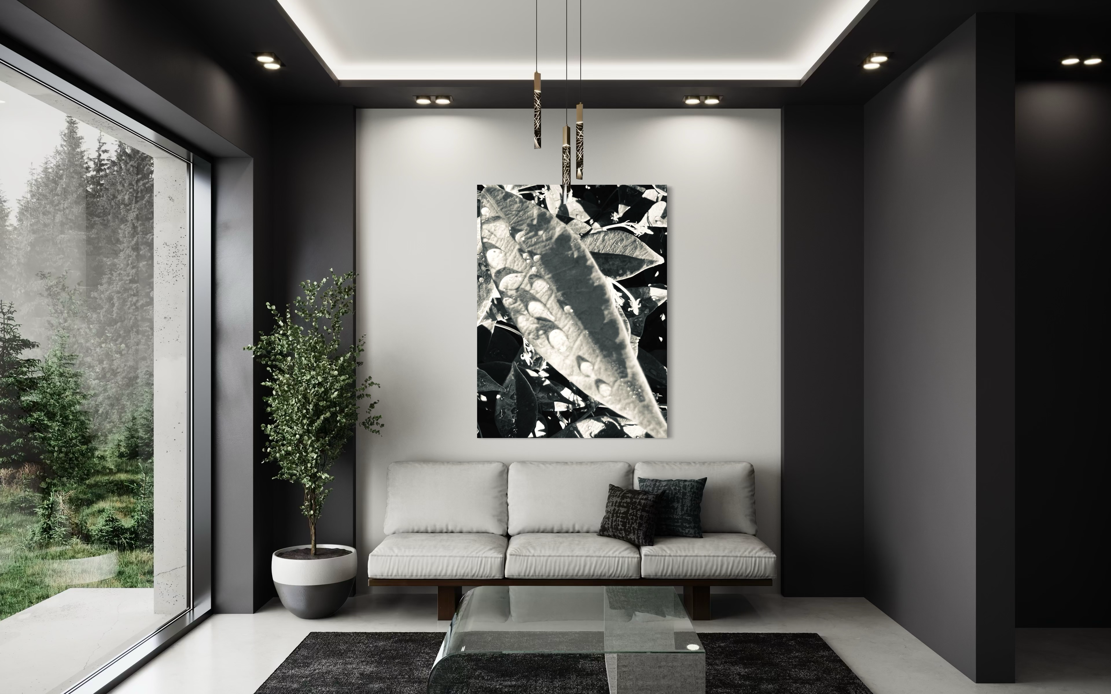 Umbra placed in a refined monochrome living room, enhancing the clean architectural lines with its sculptural leaf detail.